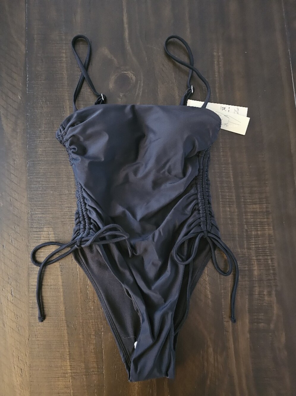 Sleek Black One-Piece Swimsuit with Side Ties